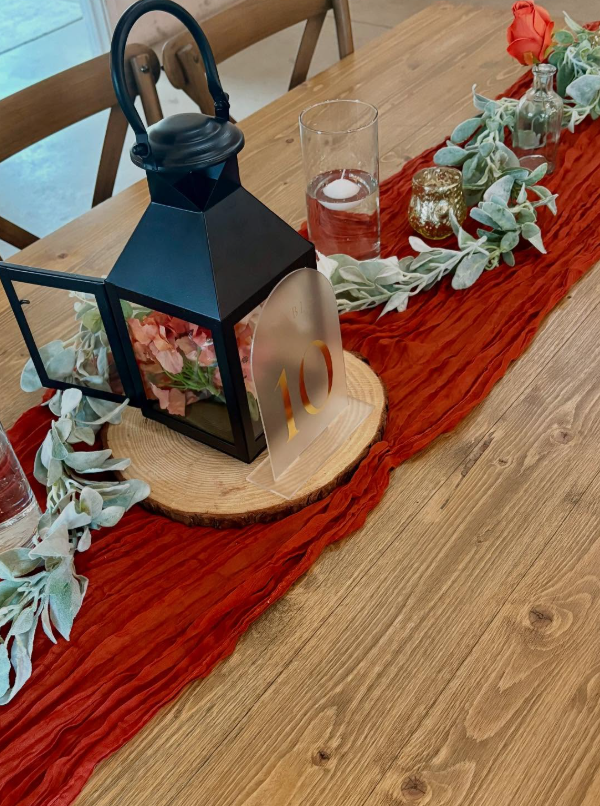 Black lantern on red table runner